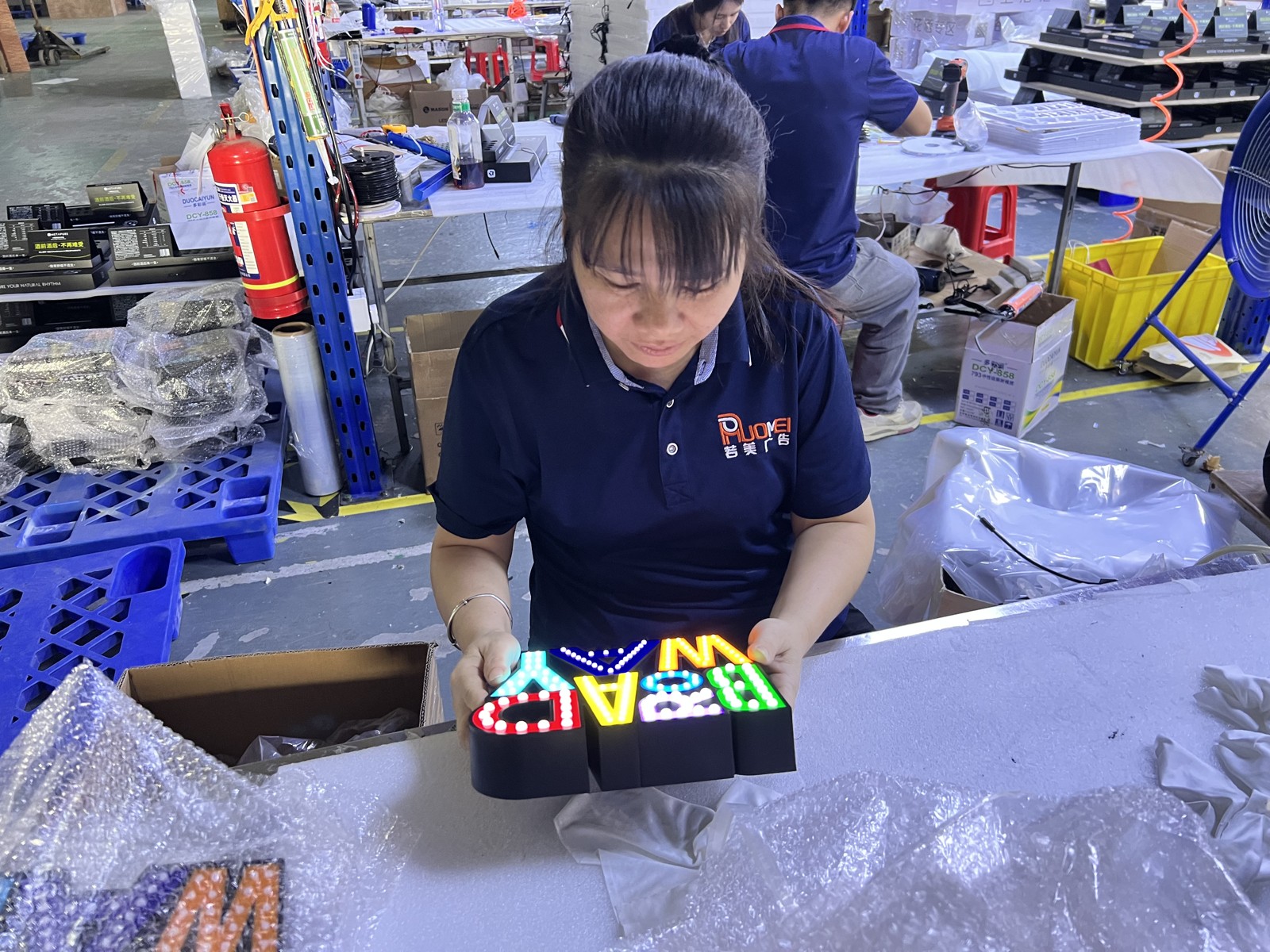 Worker inspecting the appearance of a finished sign