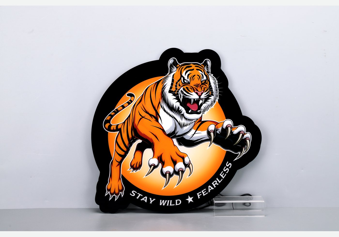 Illuminated custom-shaped tiger logo light box photographed as a complete product
