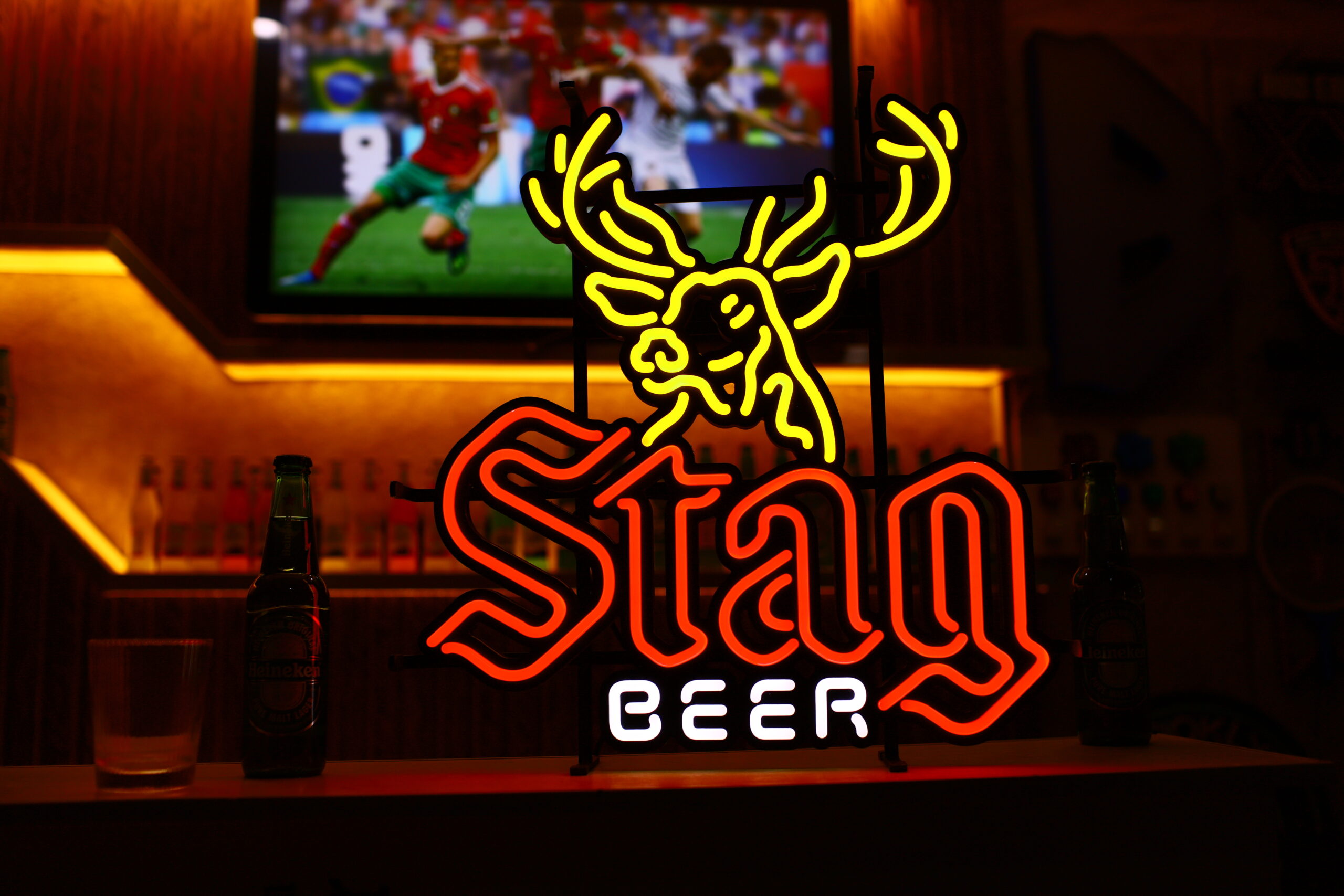 Custom illuminated neon logo product with a dark supporting frame